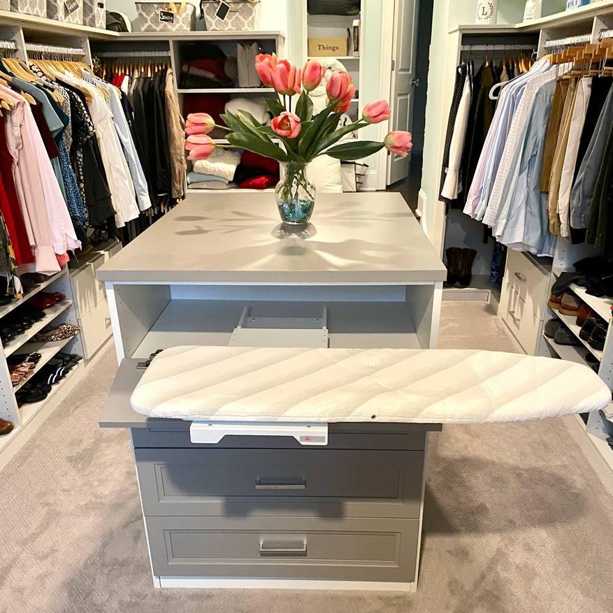 Custom Closet with Built-In Ironing Board A custom-built walk-in closet with an integrated ironing board attachment.