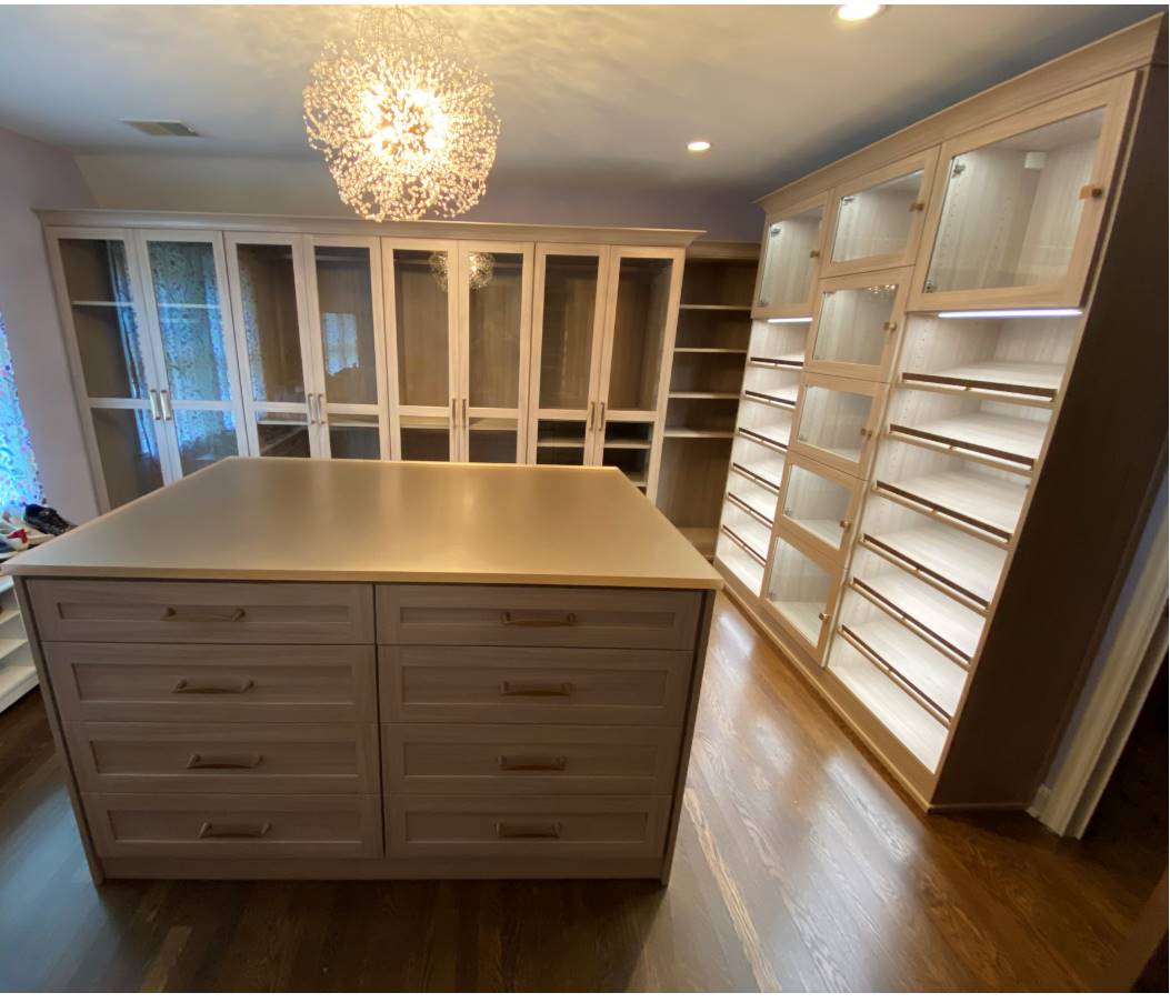 Walk-in with center island Walk-in Closets with everything you need! Glass doors, island with drawers lighted shoe shelves.
