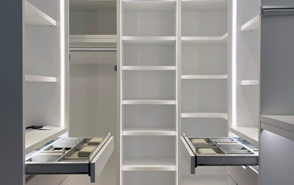 Luxury White Walk-in Closet empty white walk-in closet with LED lighting, luxury closet with jewlery drawer organizers, shleving and hanging Tribeca New York City