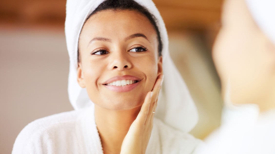 Women touching her face after having a HydraFacial.