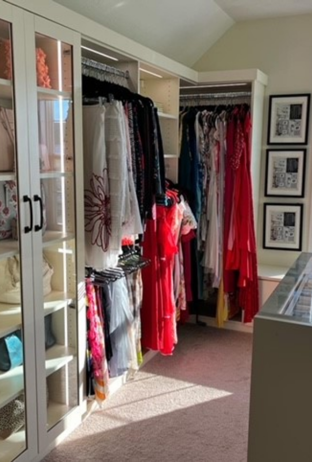 Bedroom Closet Bedroom closet with hanging space and storage shelving behind glass doors.