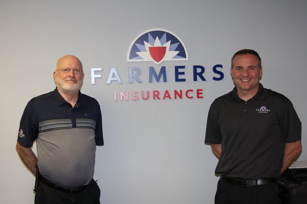 John and I by our office logo...
