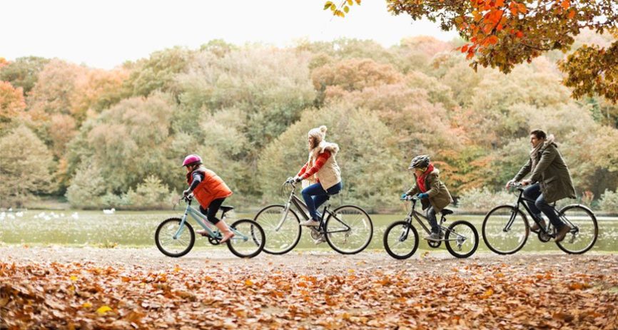 A family of four on a bike ride.