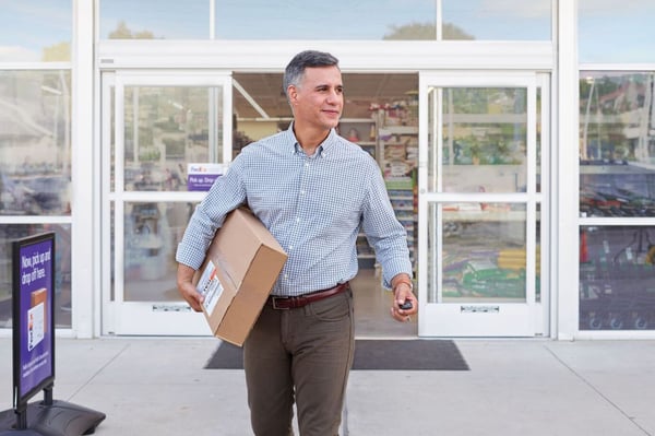 Man picking up a package from a retail location