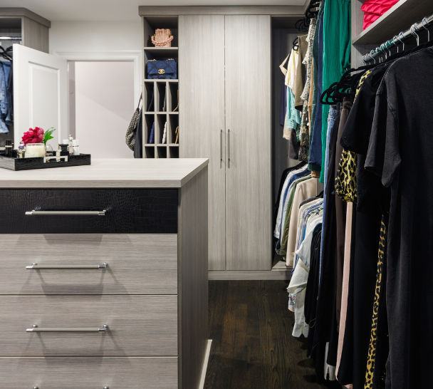 Contemporary Gray Dressing Room California Closets Rockland County NY Custom Luxury Walk in Closet Dressing Room Gray Closet Center Island Leather Drawer Faces Silver Hardware Closed and Open Door Storage Hanging and Cubby Storage