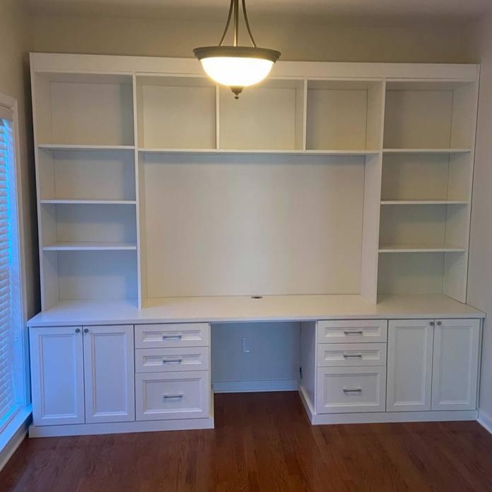 Living area white shelving Richmond - Custom closets - White entertainment center with shelves and drawers surrounding a cutout for a TV