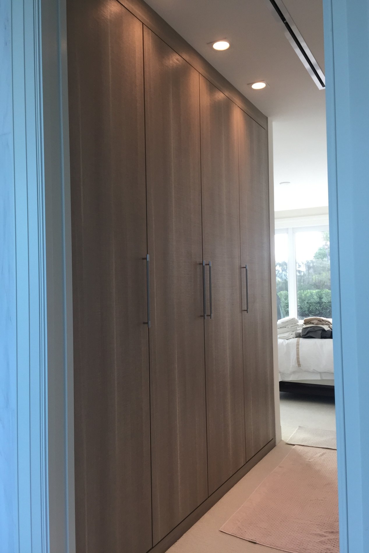Sleek Pietra Wardrobe with Custom Leather Handles and Flush Fascia Base WARDROBE in PIETRA with CUSTOM LEATHER HANDLES and a FLUSH FASCIA BASE