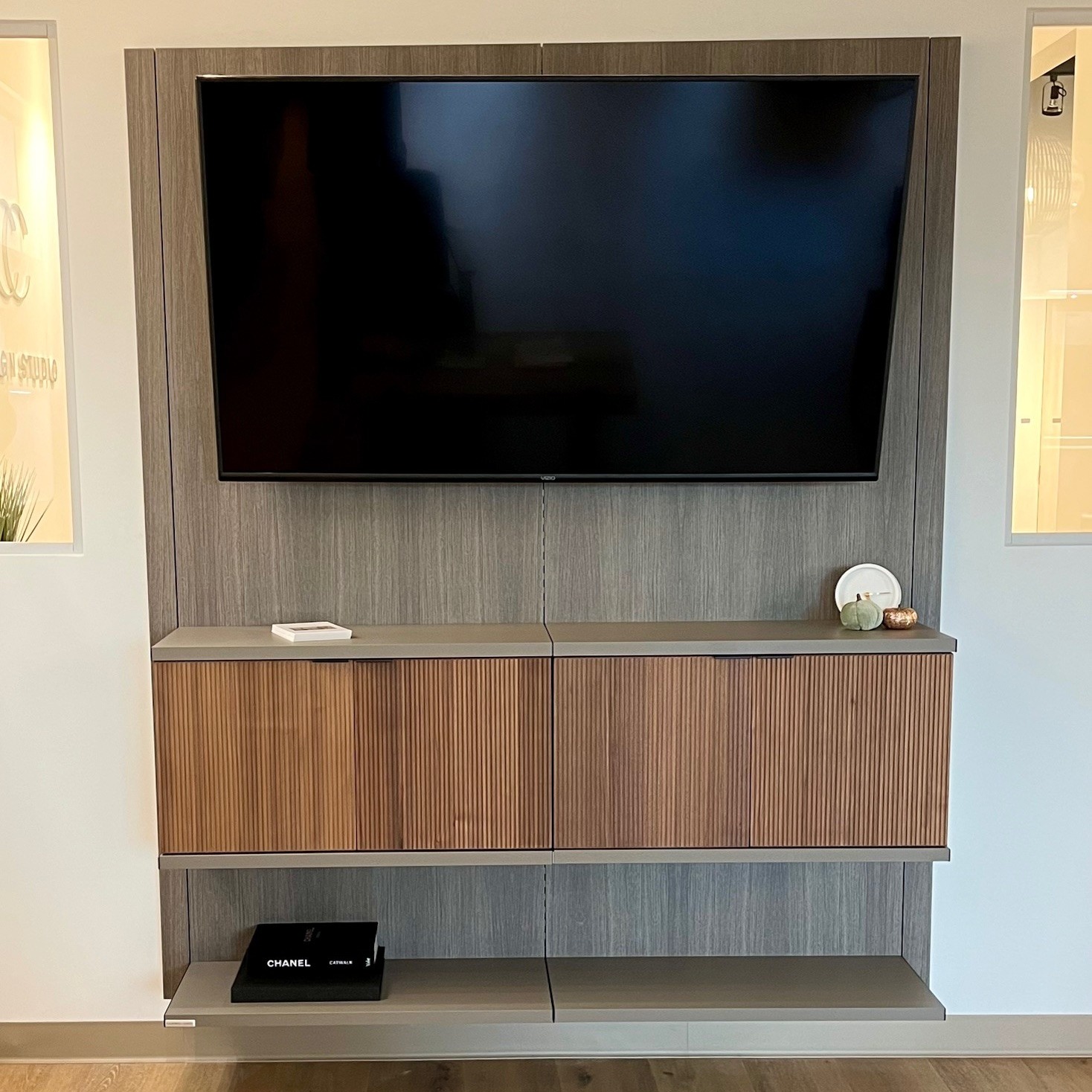 Floating Media Center Sleek floating media center with bookcase and bookshelves California Closets Pensacola & Panama City, Florida.