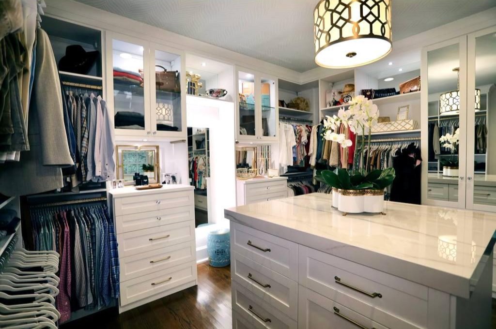 Luxury Walk-In Closet with Statement Island A luxury walk-in closet with a central island of drawers.
