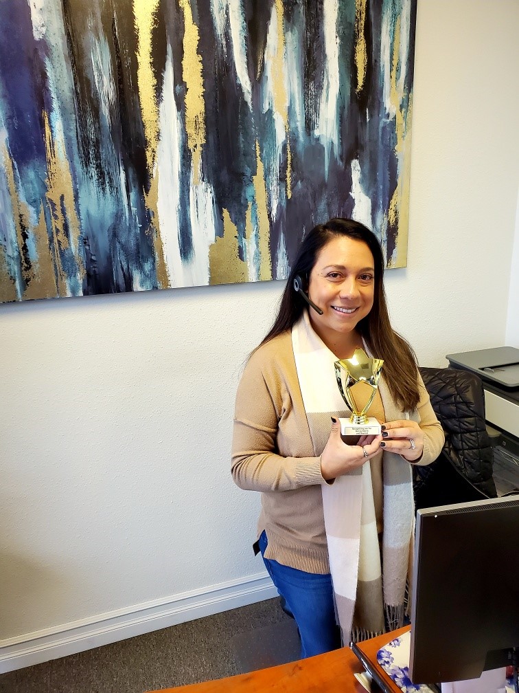 Gabby winning the Above and Beyond service award