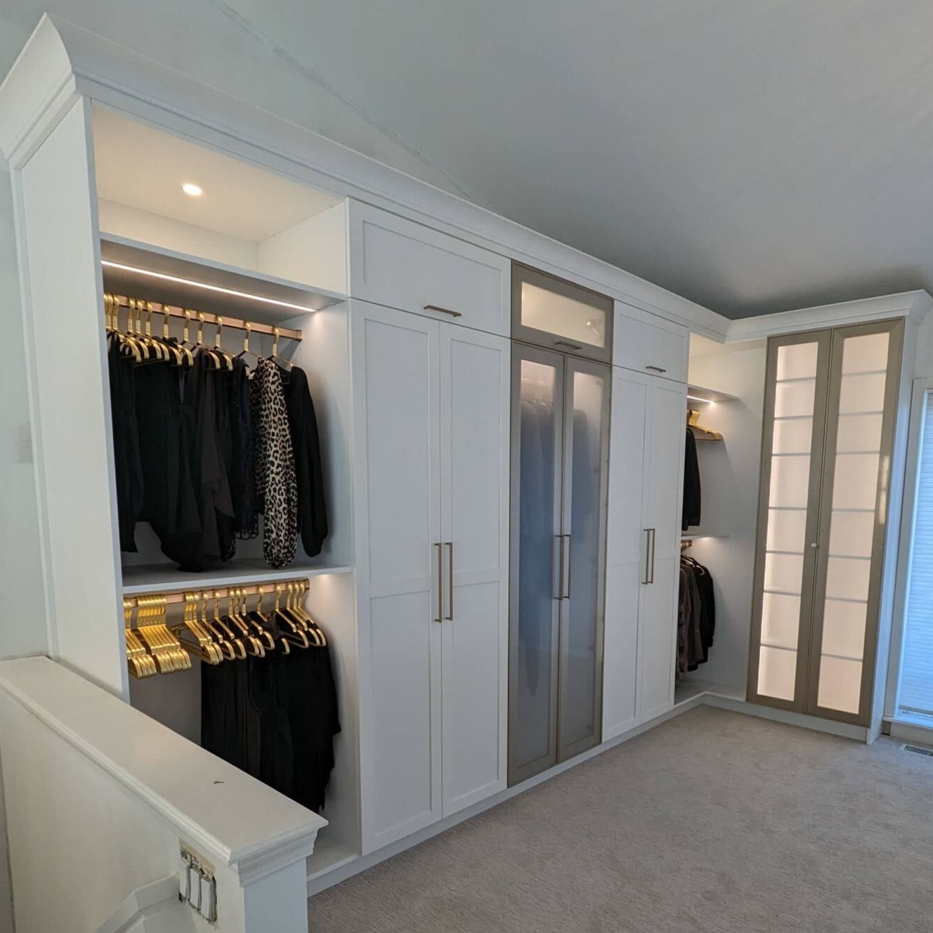 Custom Changing room Walk in Closet with integrated lighting and frosted doors