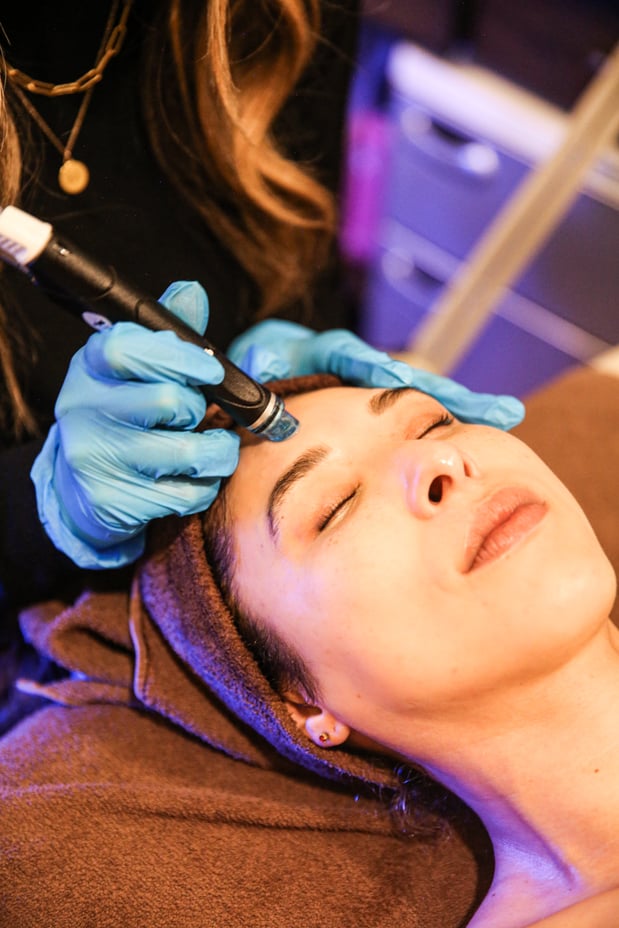 Woman receiving a HydraFacial at Woodhouse Spa