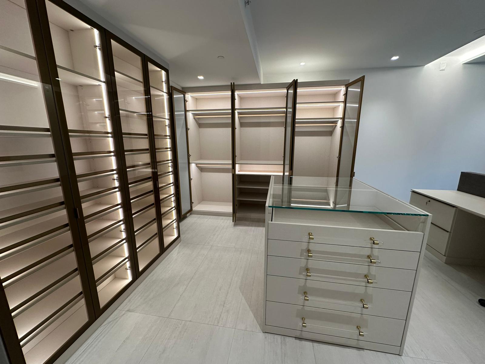 Modern closet and work space! Modern closet with mix and match glass inserts, aluminum frames, shelving and island