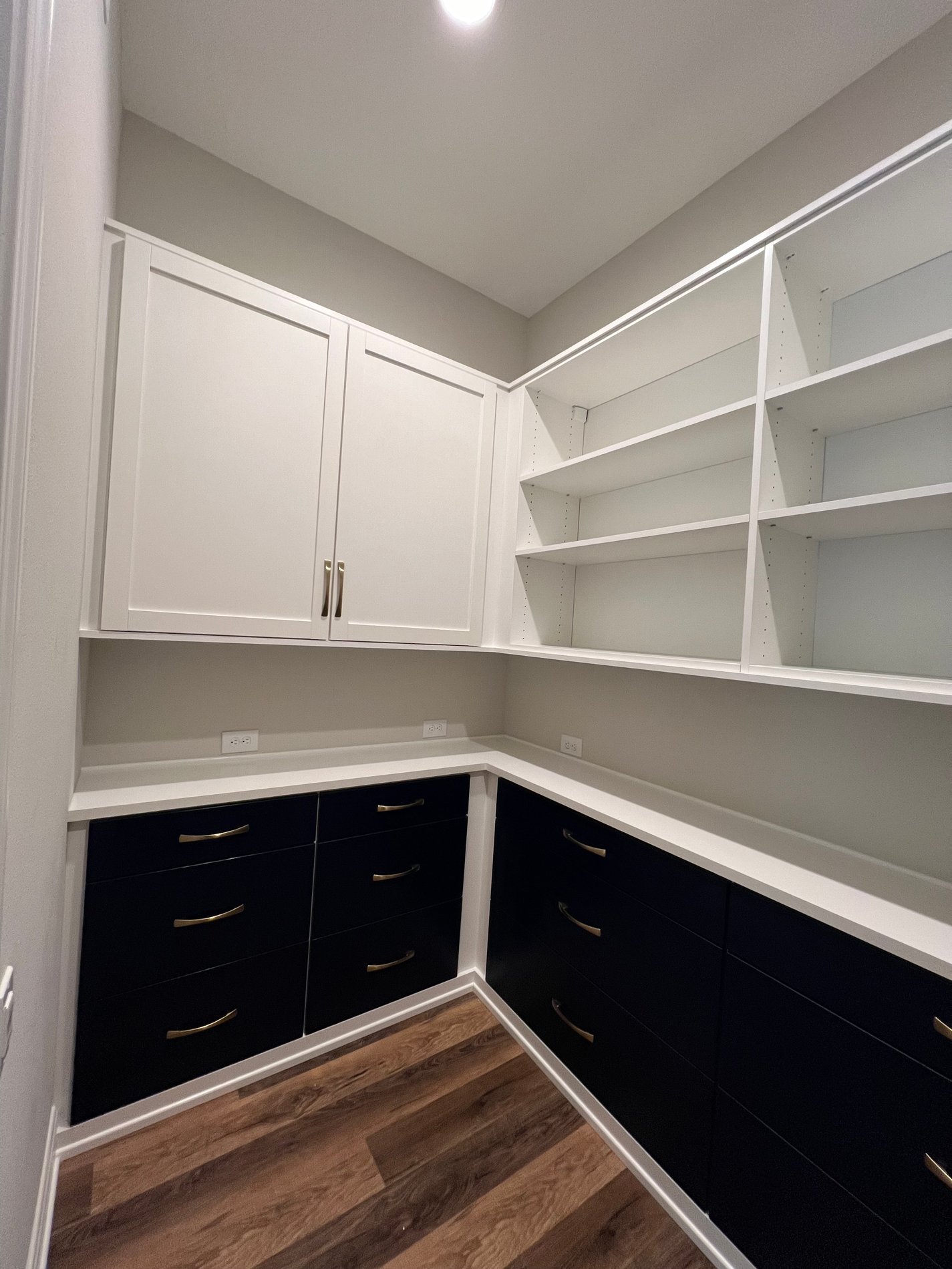 Elegant Butler's Pantry with Dove Board & Navy Supermatte Accents Butler's pantry combined with Dove finish and Northern Contours Navy Supermatte drawer fronts and gold hardware.
