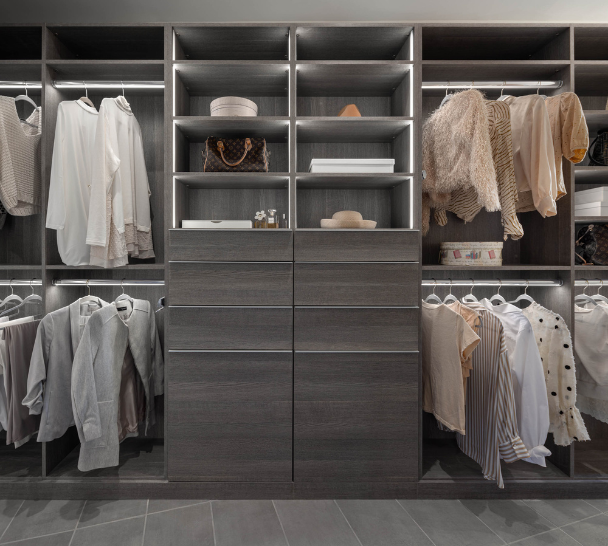 Perfectly Balanced Walk-in Closet Dark Gray walk-in closet with drawers in the middle, tilt-out hampers, LED lighting, shelving and double hanging on either side Cold Spring New York Dutchess County NY