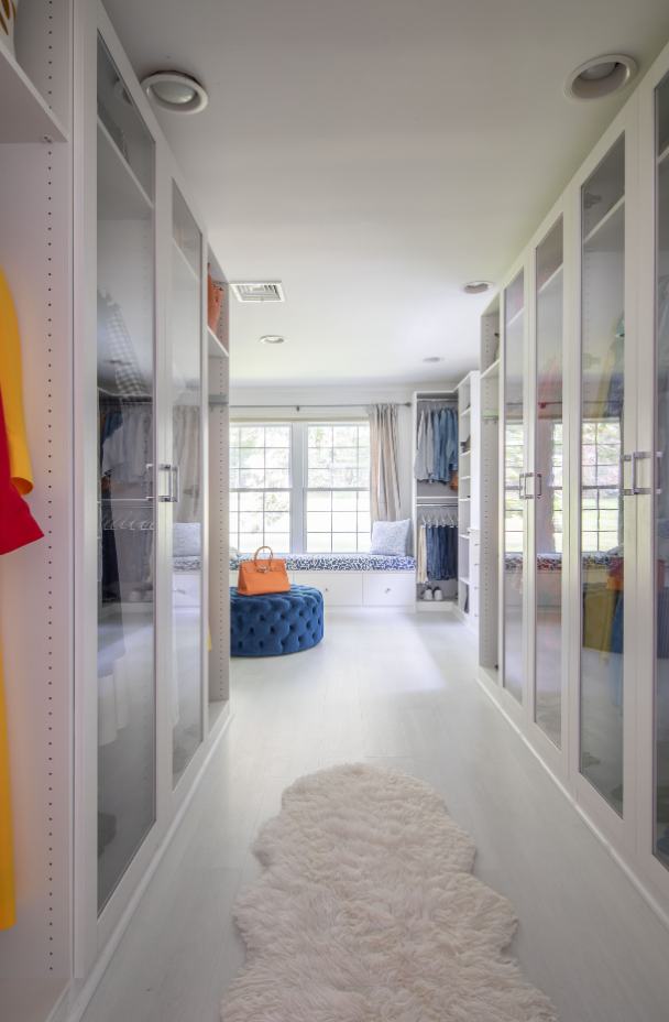 Elegant White Walk-in Closet California Closets Westchester NY White Walk-in Closet Closed Cabinetry with Clear glass Doors Hanging and custom shelving