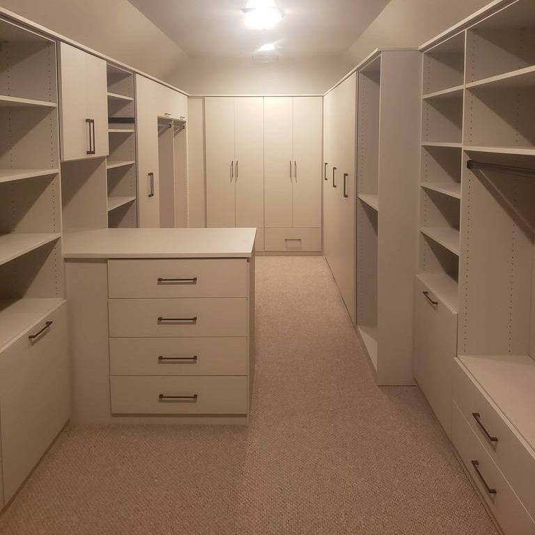 Full Room Closet with Drawers, Cabinets, and Storage An entire room filled with drawers, cabinets, and closet space.