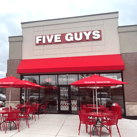 Exterior photograph of the entrance to the Five Guys restaurant in Rockford, Illinois.