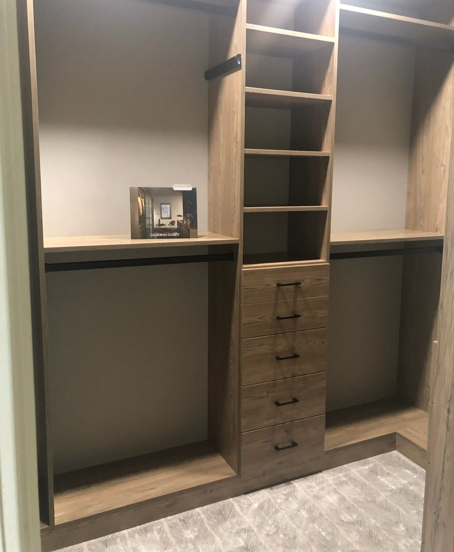 Sophisticated Walk-in Closet Brown walk-in closet with drawers, shelving, and hanging space.