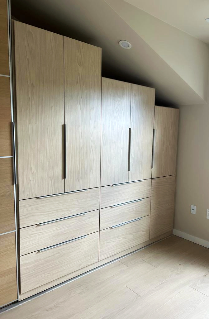Tiered wardrobe under angled ceiling a tiered height wardobe built underneath an angled ceiling