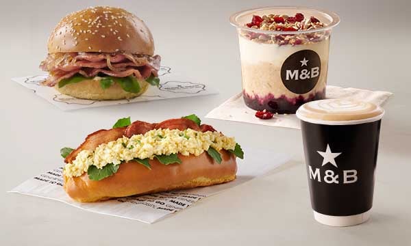 Takeaway breakfast and brunch meals including a Beef Macon & Egg Mayo Roll, Breakfast Bun, Oat Pot, and a takeout coffee from Mugg & Bean On-The-Move Makro Cornubia OTM LS.