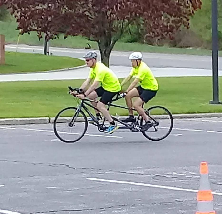 Agent Donn Sharer volunteers as a guide for Achilles International Triathlon Camp.