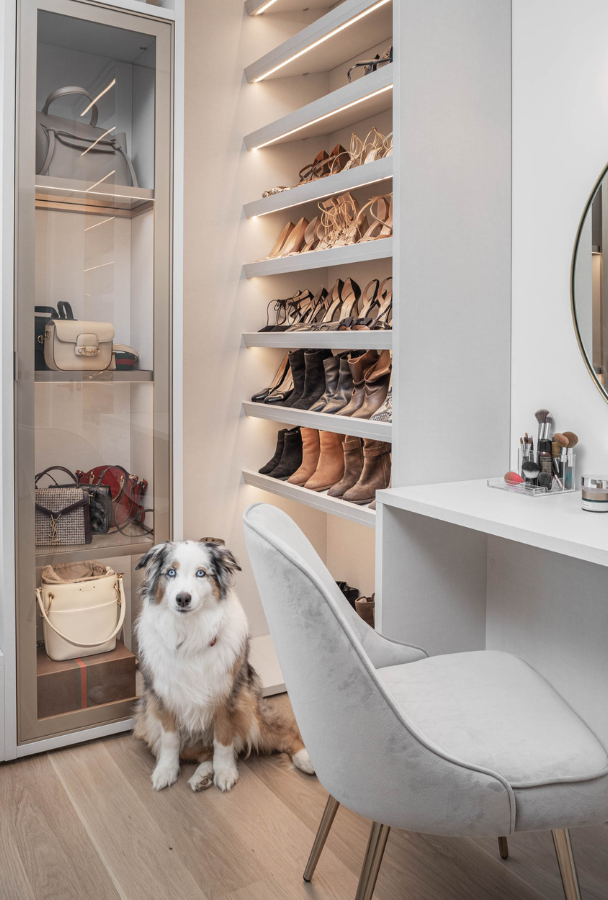 Luxurious Shoe and Bag Storage! Img 3 - California Closets Westchester County New York Full Room Walk-in Closet Marbel Center Island Custom Shoe Shelving Middle Vanity with Mirror, LED Lighting and Bag Storage with Clear Glass Doors