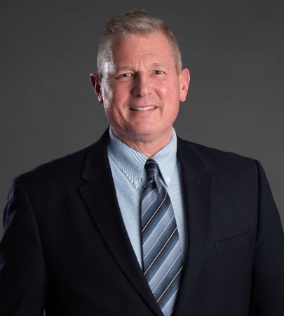 Male agent Robert Hecht profile photo in front of a grey background