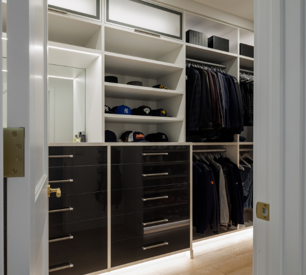 Modern High Gloss Black Walk-in Closet California Closets Rockland County NY Luxury Men's Closet Walk-in Closet Modern Closets Custom Storage Solutions Closet Shelving Leather hardware double hanging overhead storage vanity mirror