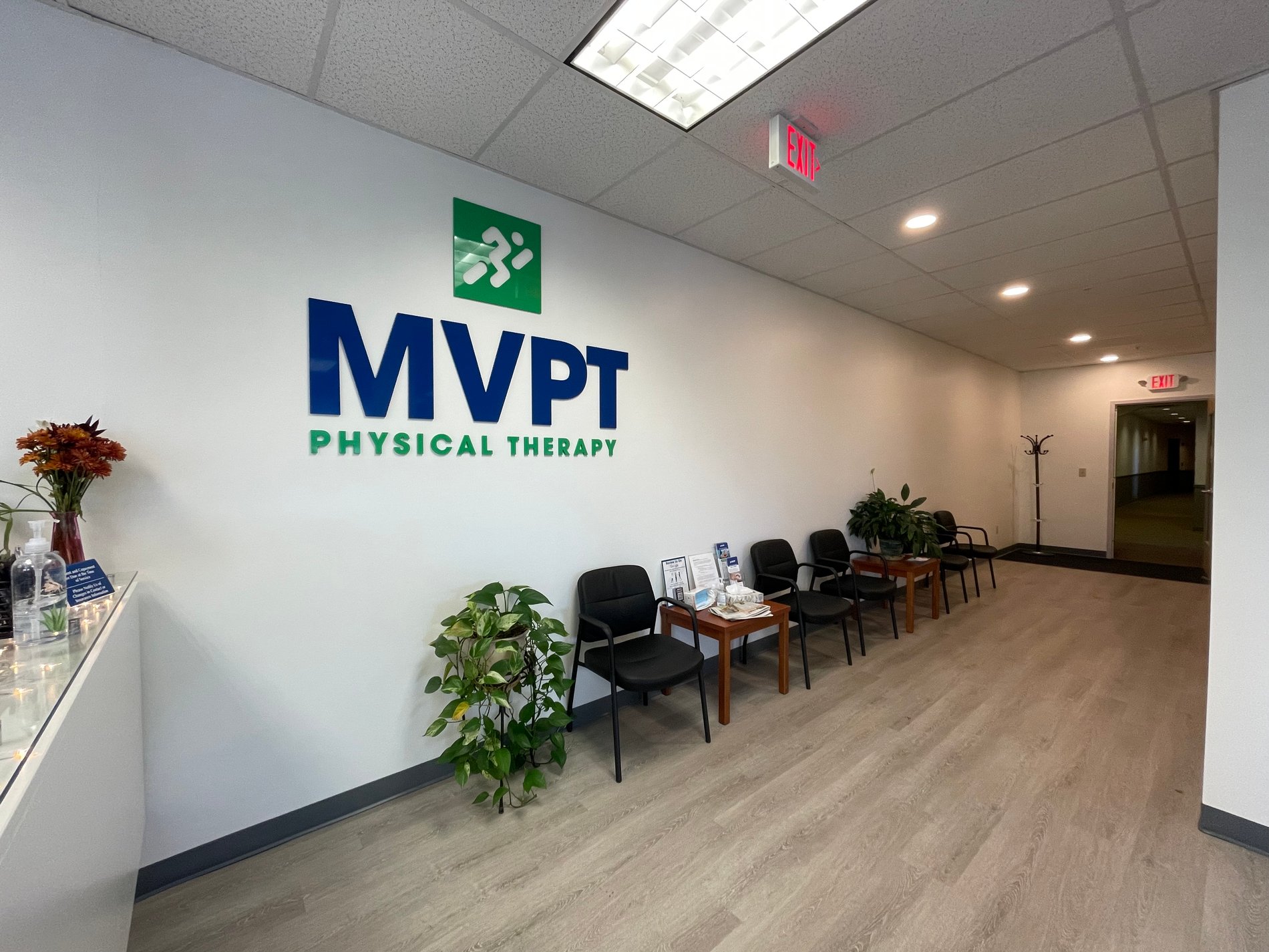 ME-Topsham-MVPT patient waiting room area with logo on the wall.