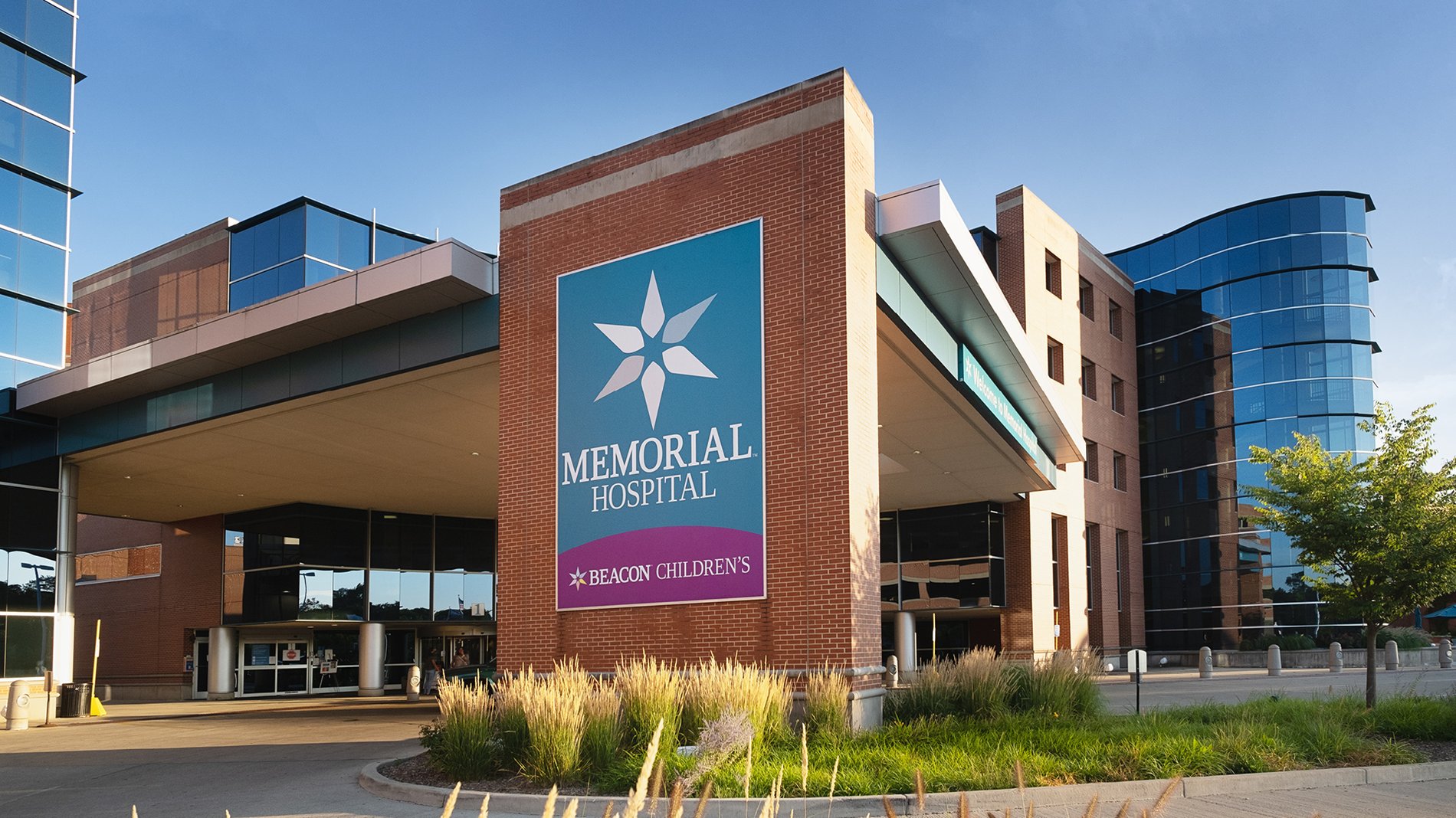 The entrance to Beacon Memorial Hospital includes a driveway with an overhang. A sign says "Beacon Children's."