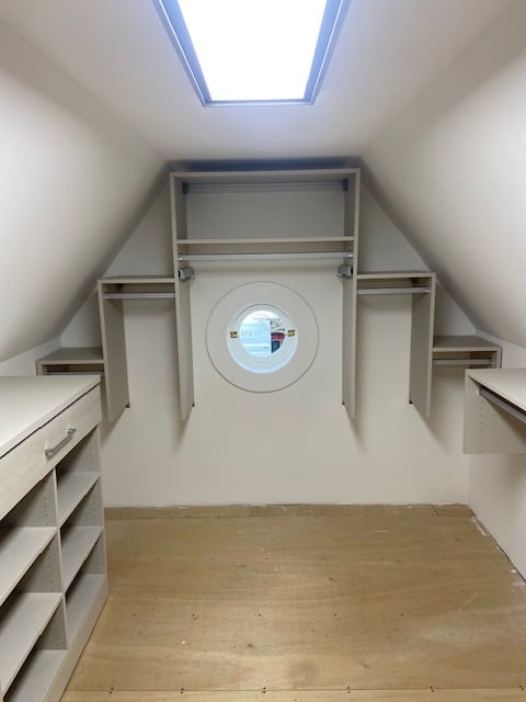 Attic Walk-in Closet Slanted roof lines with a stair step shelving design