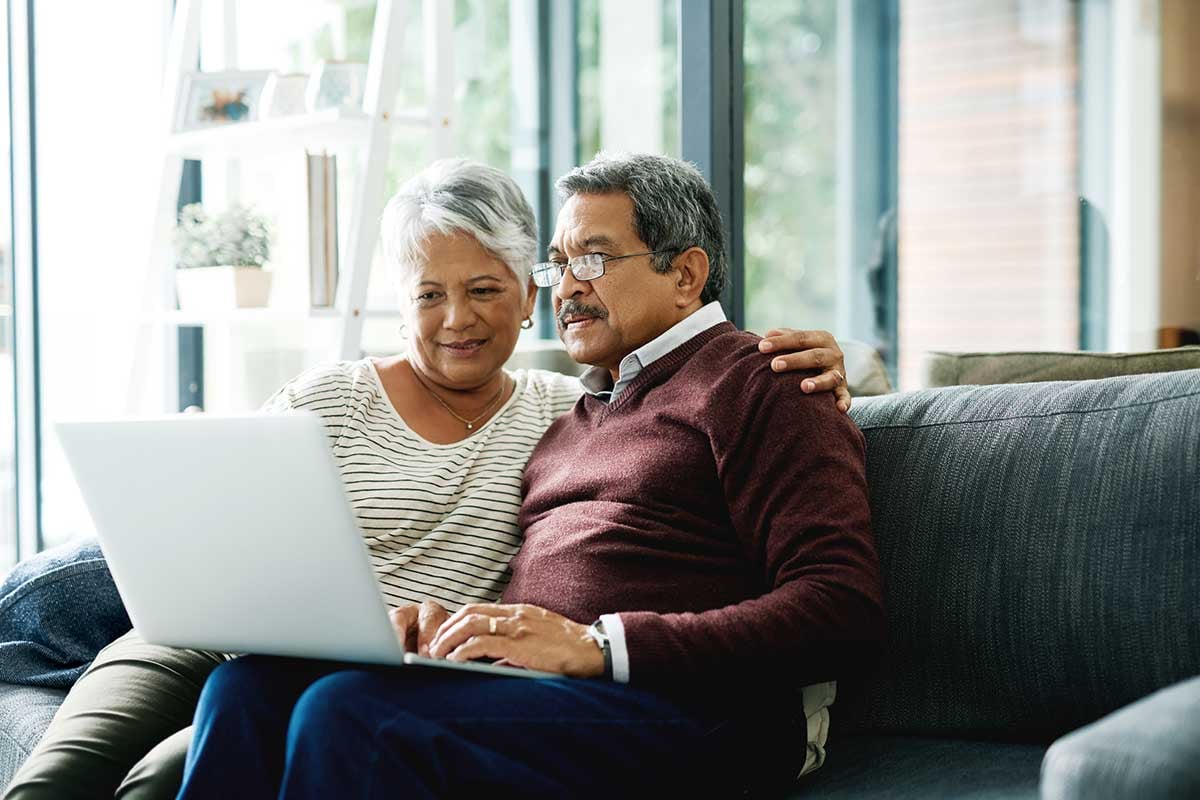 Couple using a computer together to access their patient account.