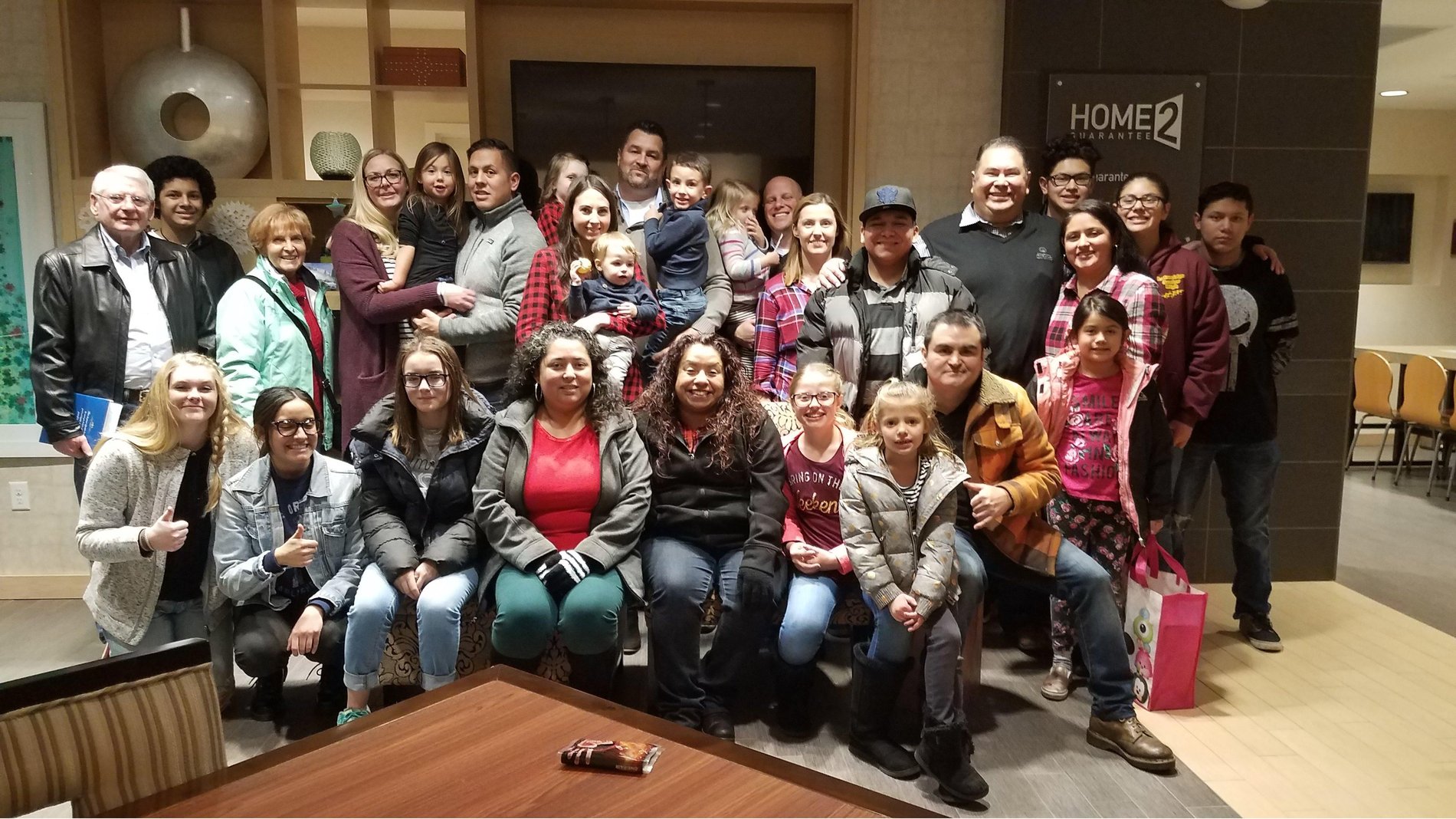 Office Christmas party with employees and families.