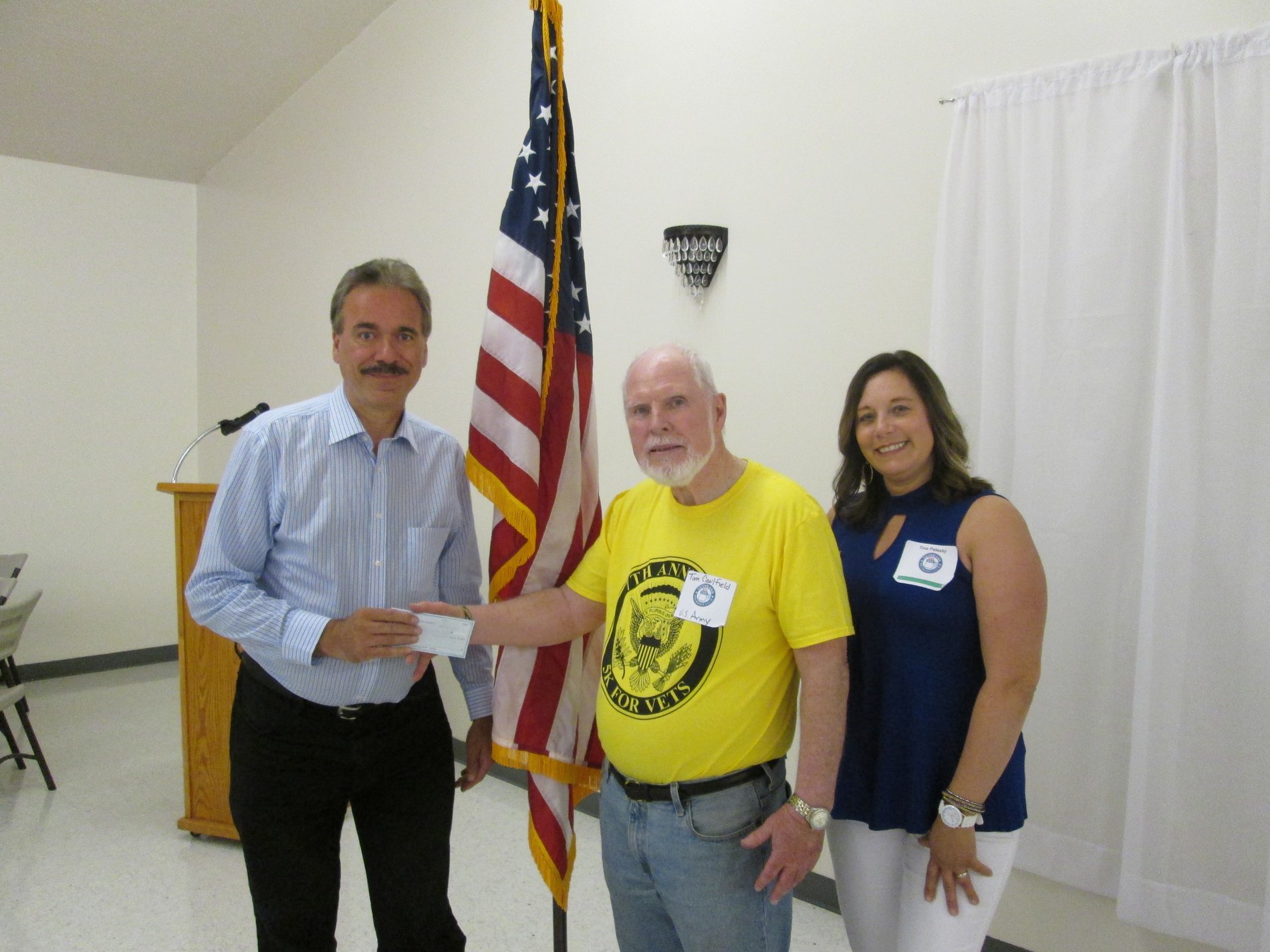 Duaine Detrick (Allstate agency owner) presents a $1,000 Allstate Foundation Hands in the Community Grant check as a volunteer to Veterans Community Initiatives, Inc..