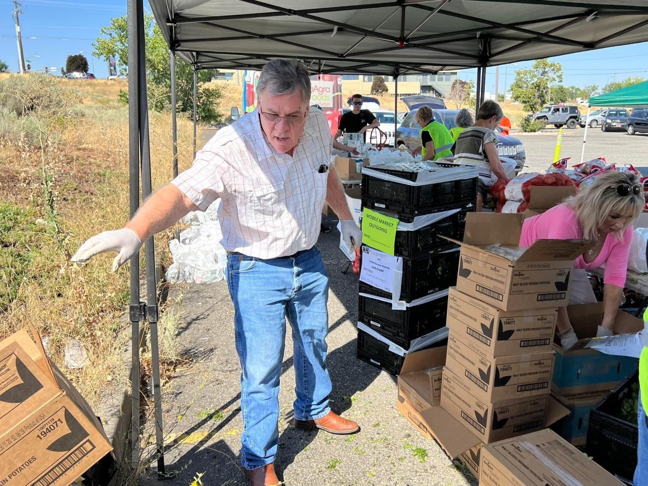 Volunteering with a group of people delivery food from 2nd Harvest Tri-Cities Food Bank