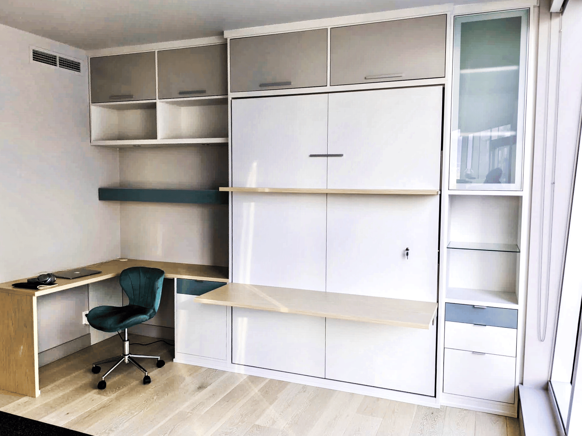 Office with wall bed Office with wall bed featuring a desk and shelf that can be used when the bed is tucked away