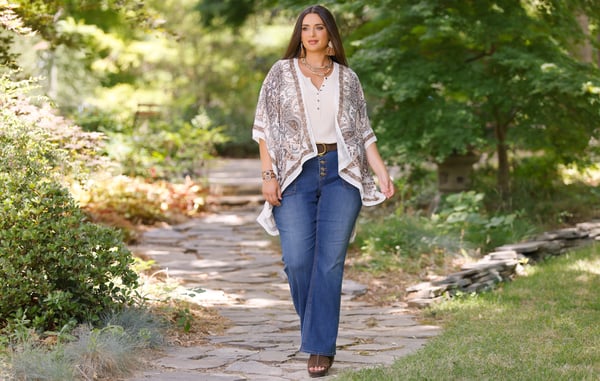 Woman is wearing plus size bootcut jeans.