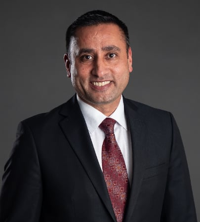 Male agent Parminder Sandhar profile photo in front of a grey background