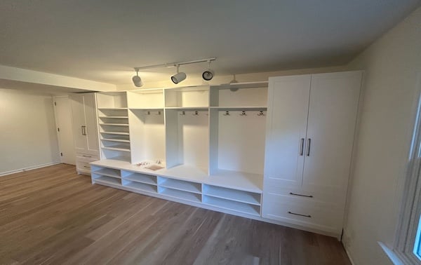 Custom Family Mudroom Custom family mudroom with white doors and shelves plus bench seating and hooks