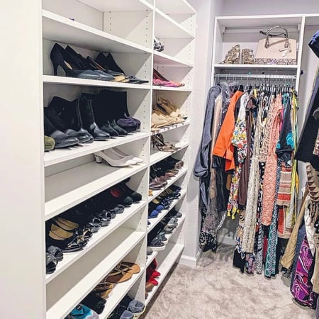 Every pair of shoes should have its place in the closet. Walk-in closet design with drawers and hanging rods by California Closets Myrtle Beach, South Carolina.