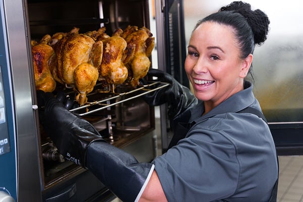 deli employee cooking chicken