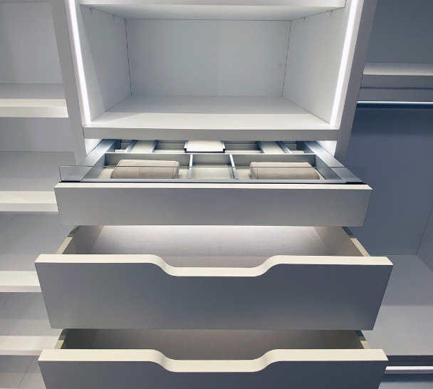 Luminous White Walk-in Closet white luxury walk-in closet with drawers with modern scoop handles and luxury jewlery drawer organizer and LED lighting Chelsea New York