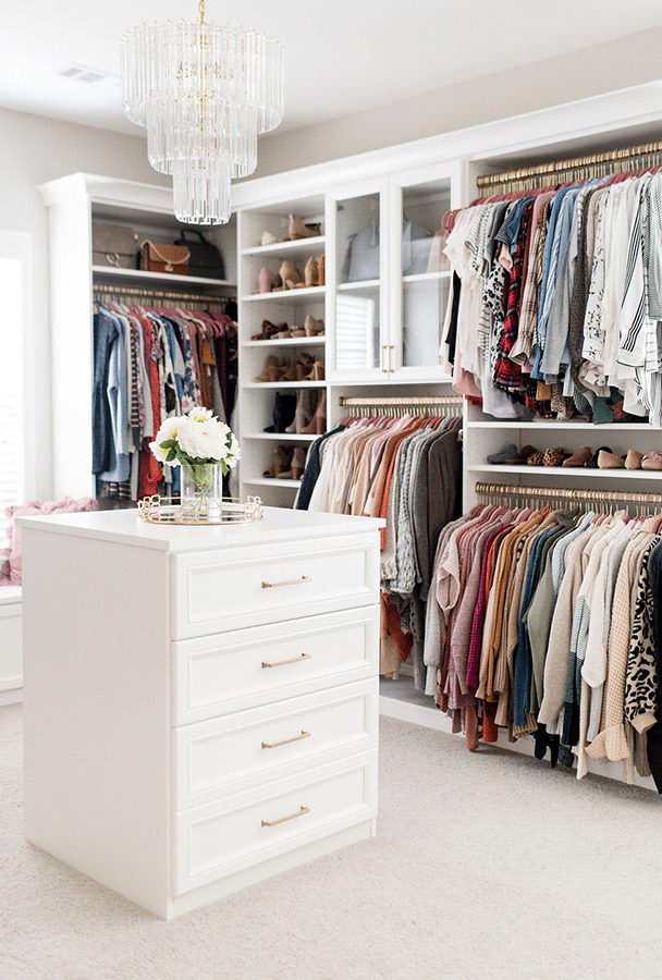 White walk-in closet with center island Luxe white walk in closet with custom storage and center island by California Closets Portland, Oregon.