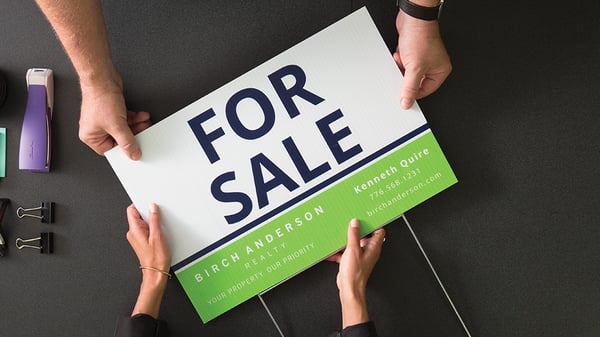 for sale sign being handed to customer