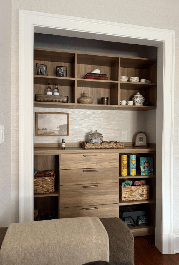 Reach-in Pantry Warm wood toned reach-in pantry with countertop, drawers in center and shelves on both sides.