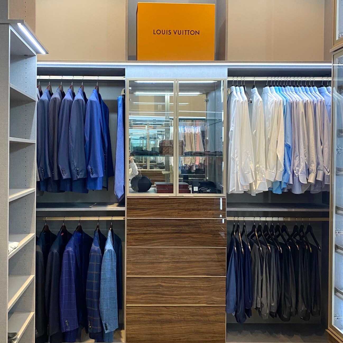 Men's Closet Dark brown men's closet organization with lighting and island California Closets New Orleans & Gulf Coast Baton Rouge, LA