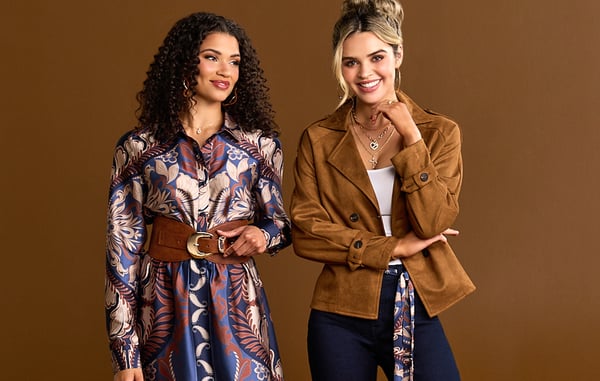 Two women are wearing brown and purple fall styles from It's Fashion.