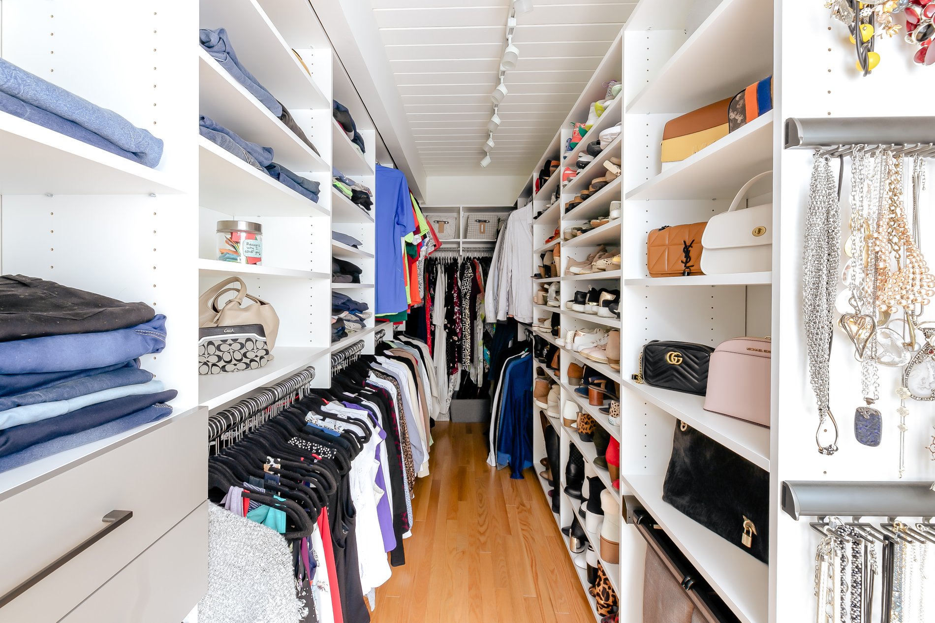 Long walk-in closet Full view of long walk in closet with shelves, hanging and pull out hanging