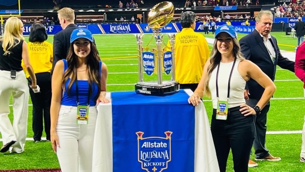 Melissa and Tiffany presenting the trophy at the Allstate Sugar Bowl Kickoff game.